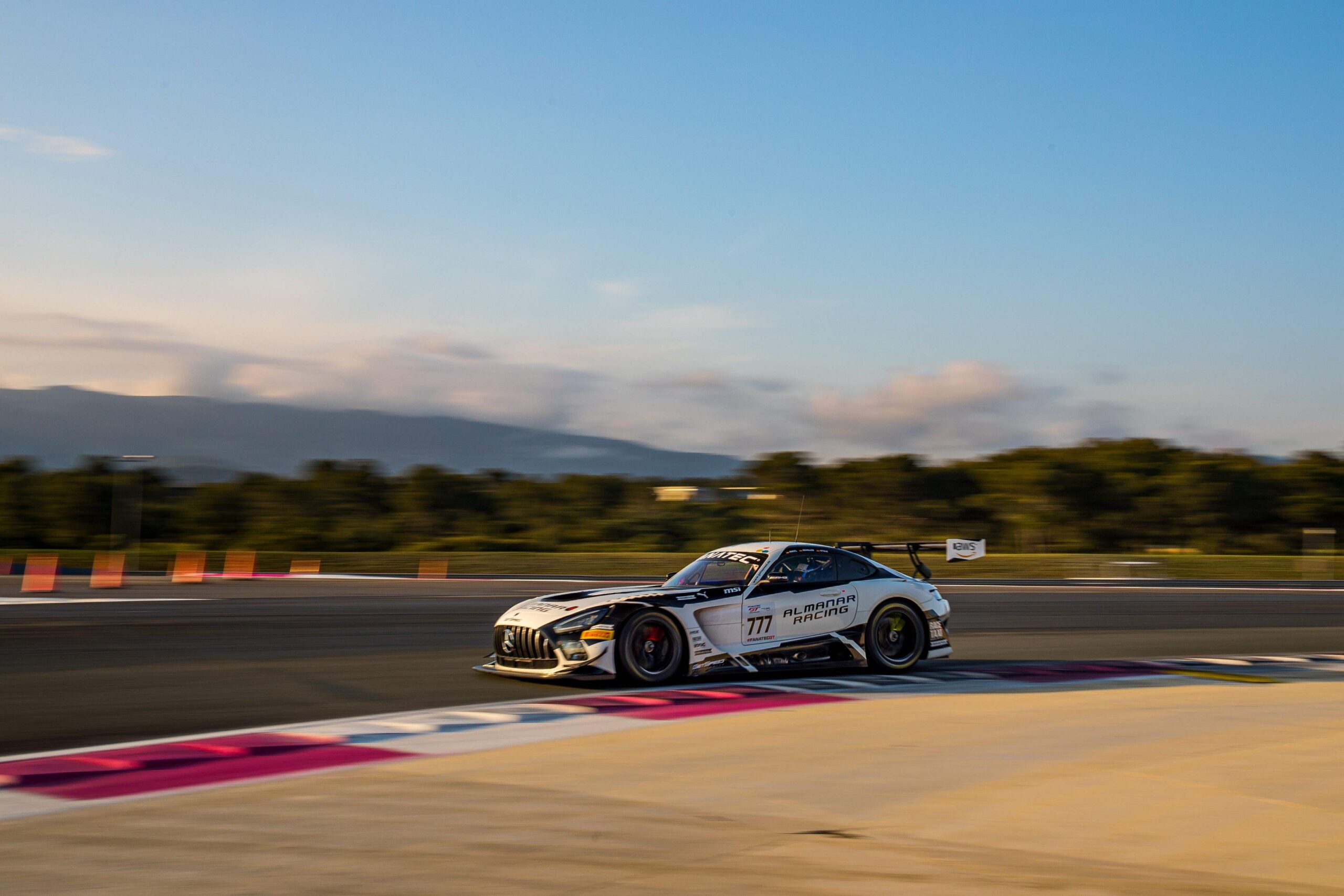 A race car speeds along a race track